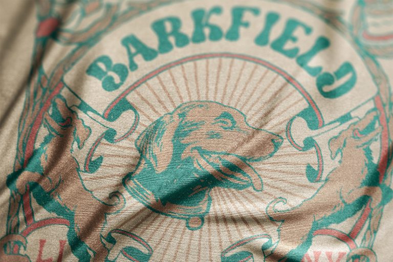 Vintage dog print on fabric, reads 'Barkfield.'